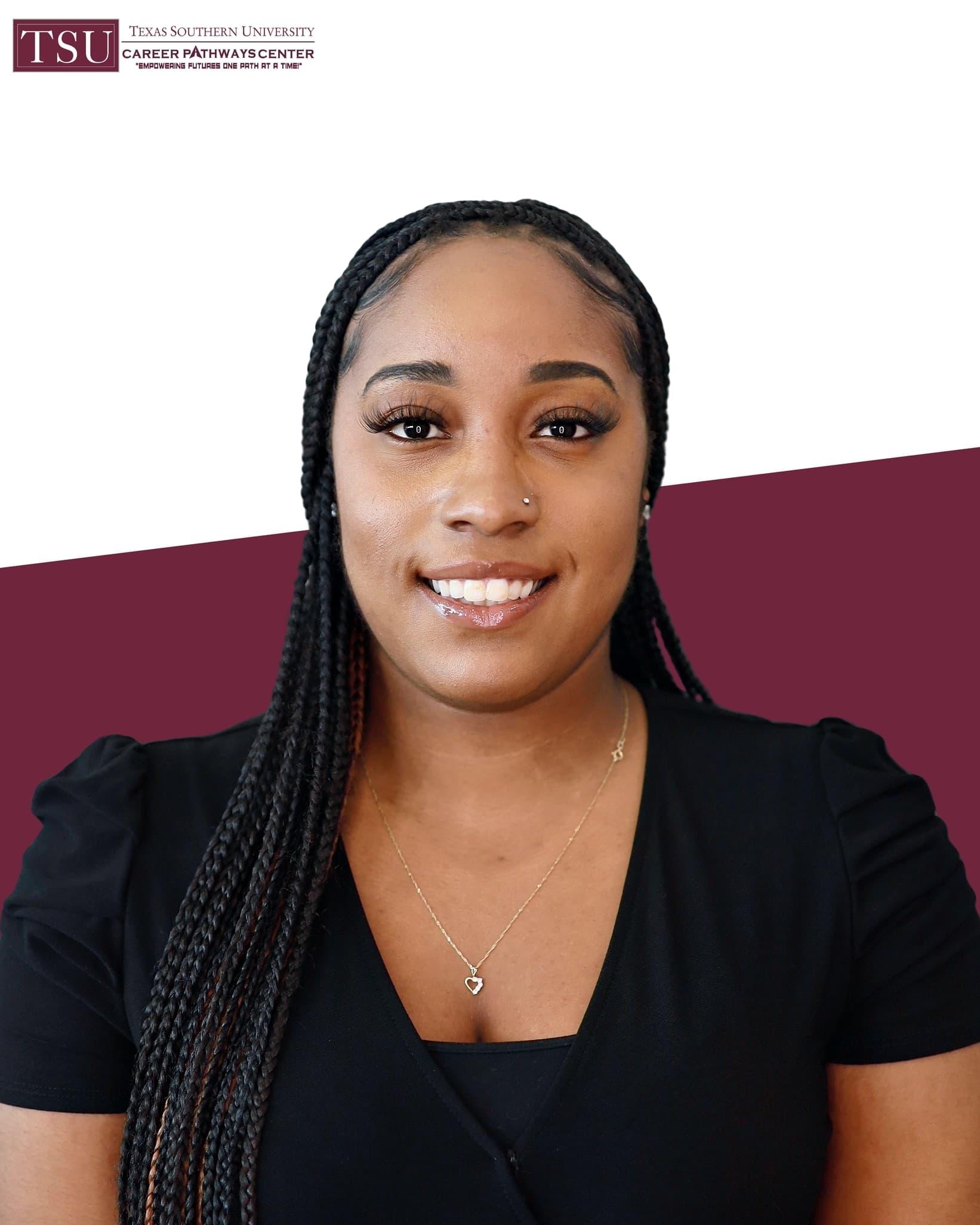 Professional headshot of a woman with long braids in a black top