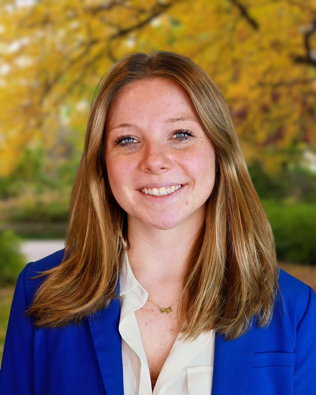 Professional headshot of a woman with long blonde hair in a blue blazer